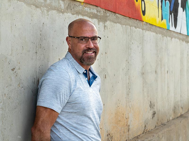 a man standing near the wall smiling