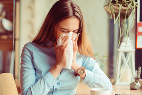 a woman sneezing