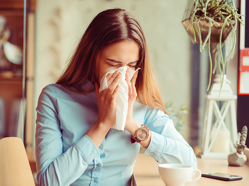 a woman sneezing