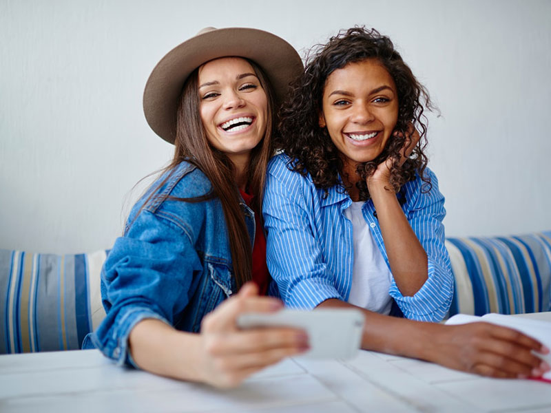 two women taking selfie and smiling