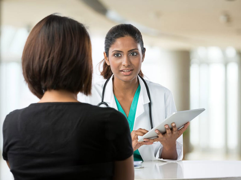 A doctor talking to a women