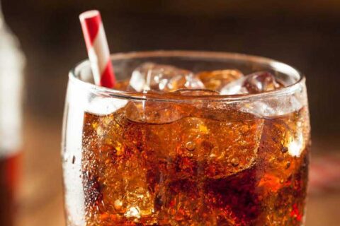 a glass of ice tea with a straw