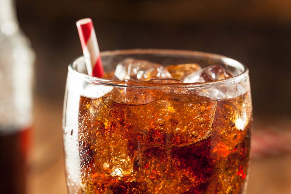 a glass of ice tea with a straw