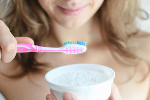 A women holding a toothbrush