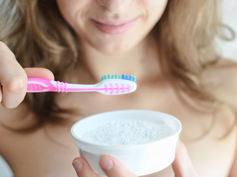 A women holding a toothbrush