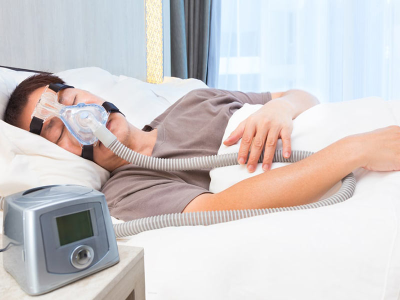 A person sleeping with sleep apnea equipment