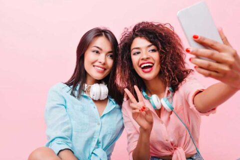 two girl smiling and capturing selfie