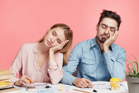 Two person sleeping while sitting